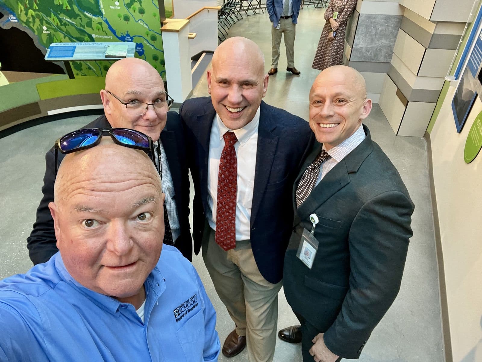 Chuck Saylors with three men during a facility visit.