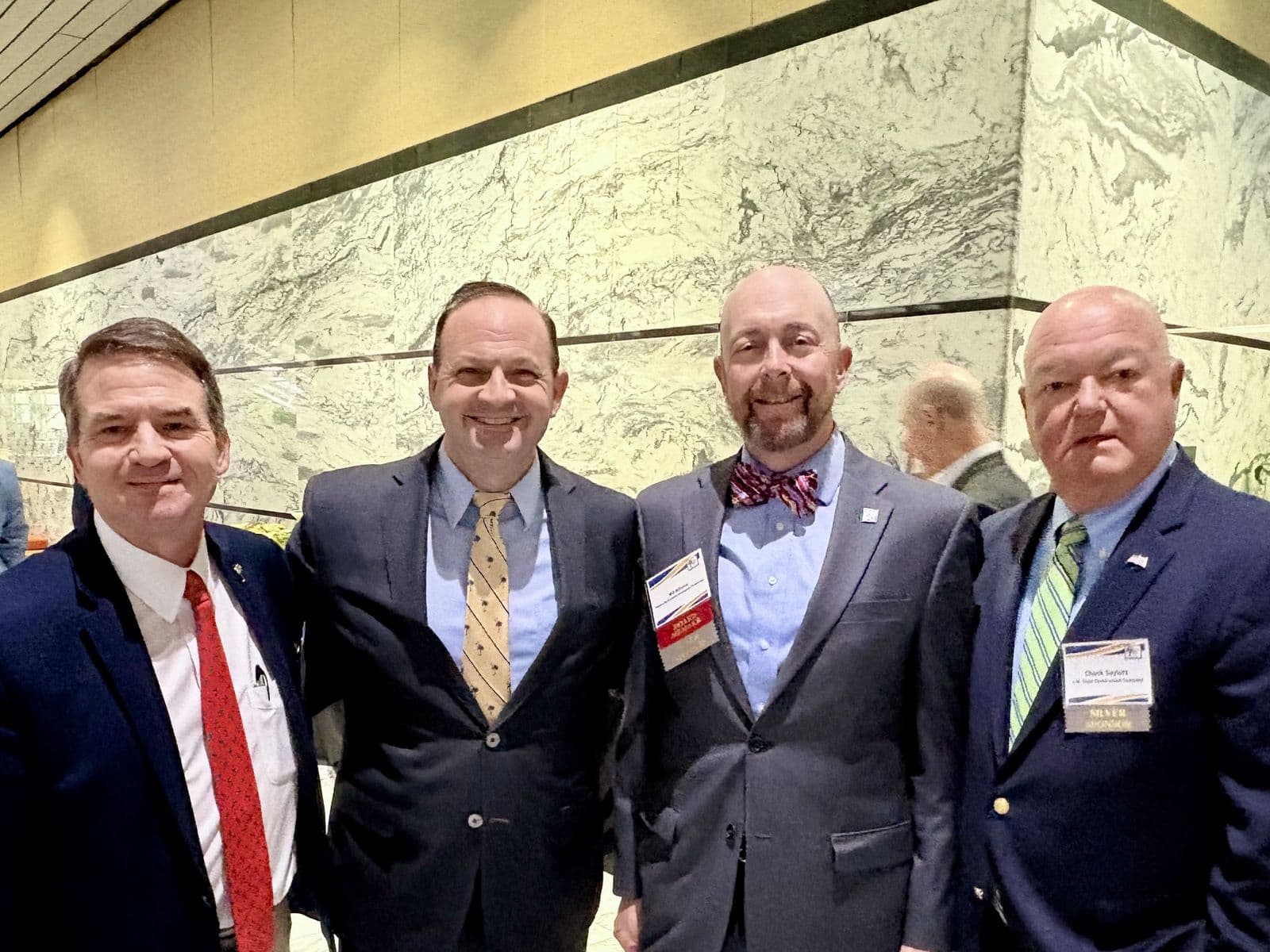 Chuck Saylors with colleagues at a conference reception.