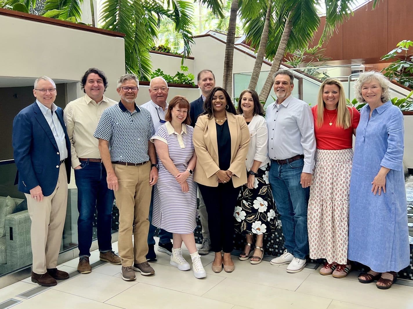 A group photograph in a garden atrium.